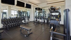 A modern gym with various exercise equipment, including dumbbells, weight machines, and cardio machines. - Central Studio | Pool/Spa/Hottub | Close to Shops & Parks (Phoenix)