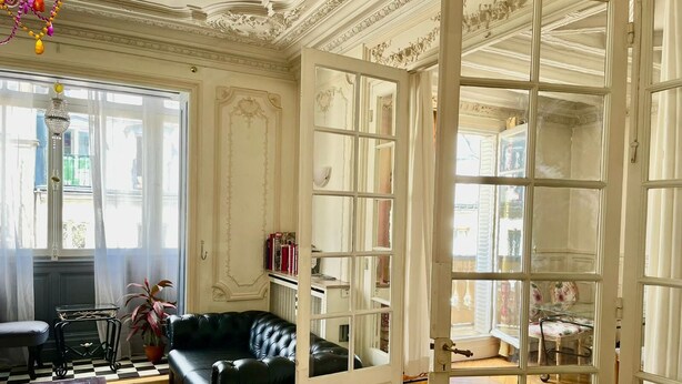 A room with a black leather sofa, a wooden coffee table, a bookshelf, and a large window with curtains. - Haussmann Opera Penthouse130M2 Exclusive full 4floors Stone Balcony (4 bedrooms)  (Paris)