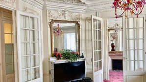 A grand room with a large mirror, a television, and a fireplace. - Haussmann Opera Penthouse130M2 Exclusive full 4floors Stone Balcony (4 bedrooms)  (Paris)
