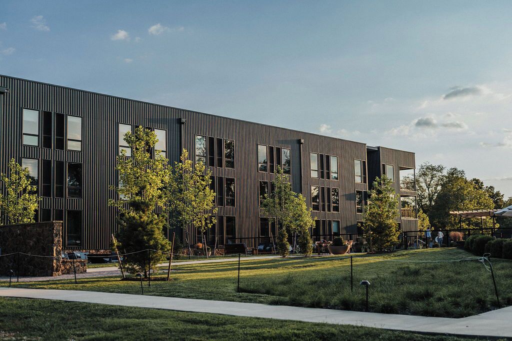 A modern building with a flat roof, large windows, and a flat facade.