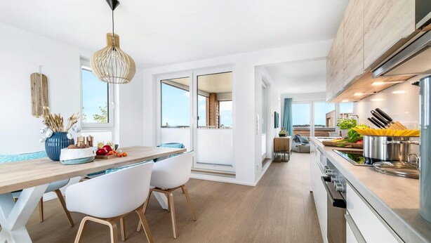 A modern kitchen with a wooden countertop, white chairs, and a large window. - Gorgeous apartment in Olpenitz (Olpenitz)