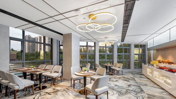 A modern dining area with marble flooring, large windows, and contemporary lighting fixtures. - Platinum International Apartments (Huiyang High speed Railway Station Xinghe COCO Store) (Huizhou)