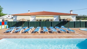 A pool area with lounge chairs and a building with a red-tiled roof. - Bungalow 'D' with Private Pool, Private Terrace and Wi-Fi (Pontevedra)