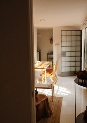 Enjoy casual dining in this modern space with a wooden table and chairs.