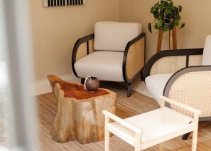 Relax in a serene space with a comfortable seating area, featuring a chair, armchair, and sofa.