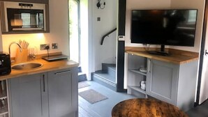 A modern kitchen with a built-in microwave, sink, and wooden countertop. - Caverswall Castle - Grade 1 Listed Historic Castle - Inquire for best quote now (Caverswall)