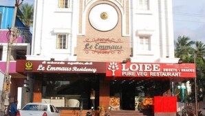 A building with a sign for Le Emmas Residency and LOIEE Pure Veg Restaurant. - Le Emerald Residency (Chennai)