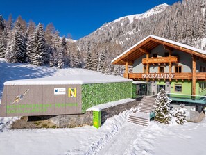 A wooden building with a sign reading 'NOCKALMHOF' and a Biosphärenpark-Zentrum sign.