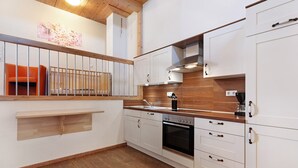 A modern kitchen with white cabinets, a wooden countertop, and a built-in oven. - Apartment 'Ferienwohnung Mirabelle' with Shared Garden, Balcony and Wi-Fi (Appenweier)
