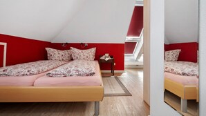 Een slaapkamer met een bed, een tafeltje en een spiegel.