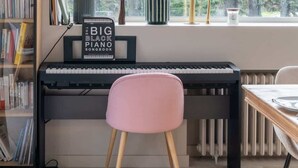 A cozy room with a piano, a bookshelf, and a window with a view of trees. - Ker Lan - Character house with Spa and sea view (Lanildut)