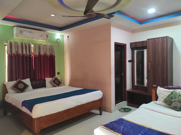 Deluxe Triple Room | Premium bedding, desk, laptop workspace, bed sheets - Hotel Manikanta (Guwahati)