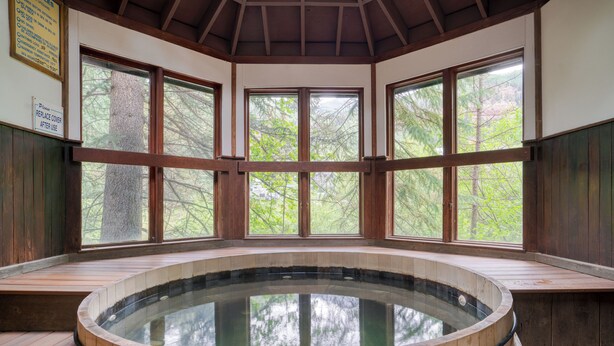 A wooden hot tub in a room with large windows and wooden walls. - Manitou River House 113 by AvantStay | A+ Location (Telluride)