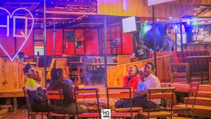A bar with wooden furniture and neon lights. - Riverside Villas Nanyuki  (Nanyuki)