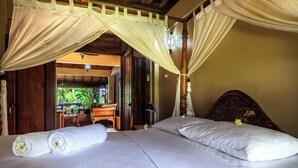 A bedroom with a bed, a canopy, and a view of an outdoor area. - Villa Seahorse, Bali - Lovina Beach Poolvilla, 2BR Joglo! (Buleleng)