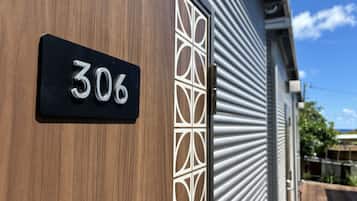 A house number sign '306' on a wooden door.