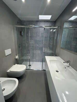 Een douche, een haardroger, een bidet, handdoeken