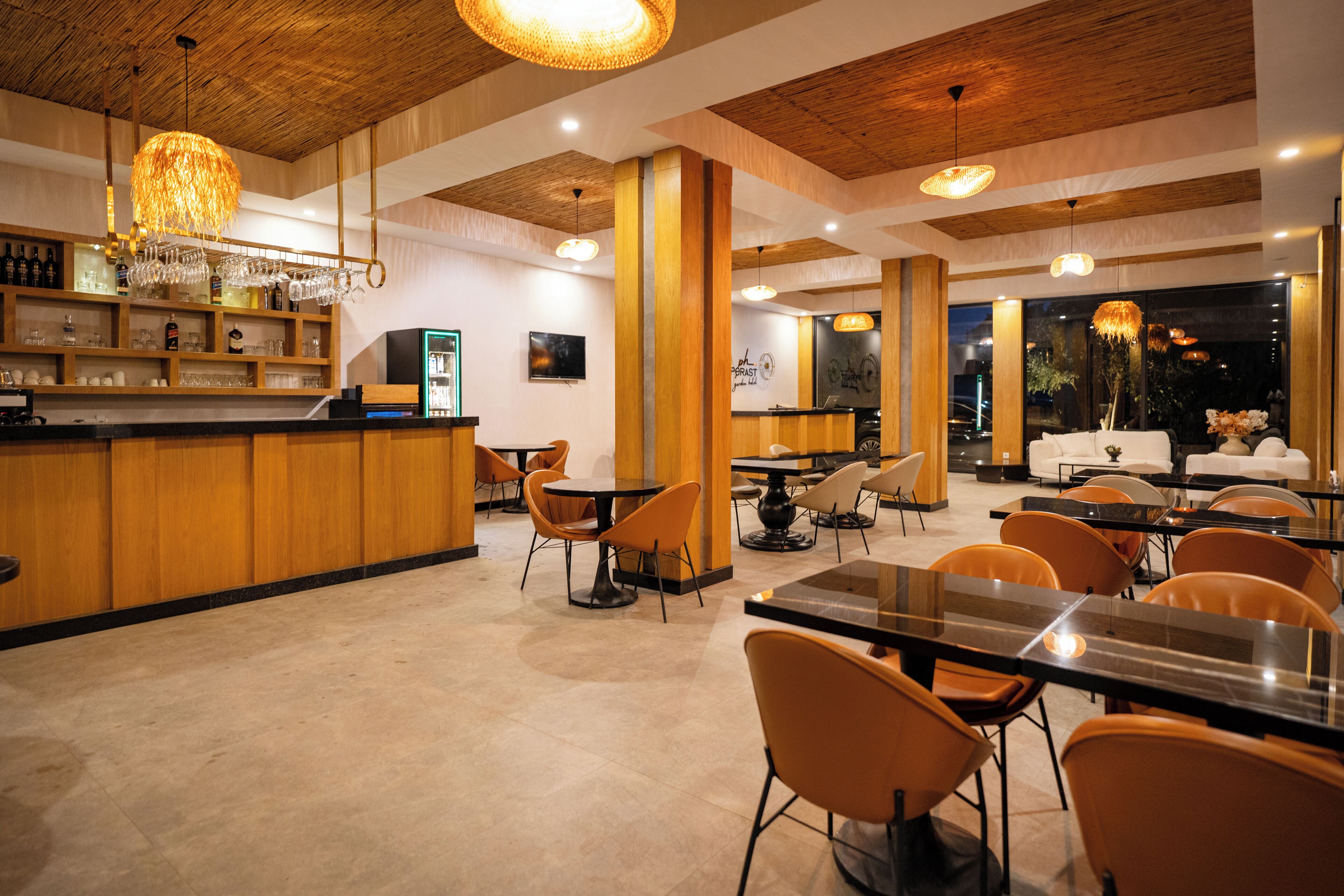 A restaurant with wooden accents, a bar area, and tables and chairs for dining.