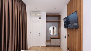 A hotel room with two beds, a TV, a mirror, and a wardrobe. - Emar Hotel (Tirana)