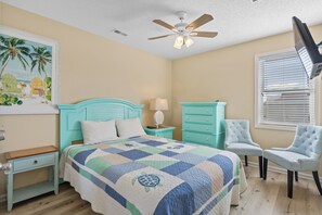A bedroom with a bed, a nightstand, a chair, a ceiling fan, and a window with blinds. - 10% off 3-7 nights thru Nov. Pet friendly home. 2nd Row. Cherry Grove. (North Myrtle Beach)
