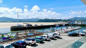 A marina with boats docked, a sandy beach, and a clear sky. - The Cliffs A Ribeira - Peizas (Foz)