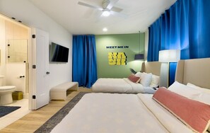 A hotel room with two beds, a TV, a ceiling fan, and a 'Meet Me In' sign on the wall. - Nash Luxe Party! 13 Beds - Priv Hot Tub/Game Room! (Nashville)