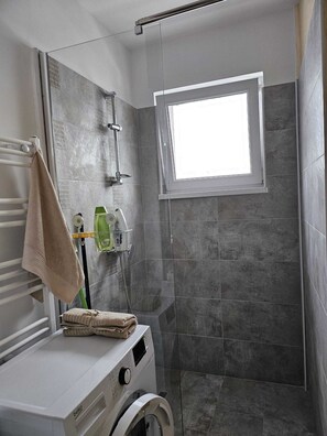 Appartement Classique | Salle de bain | Douche, articles de toilette gratuits, sèche-cheveux, chaussons
