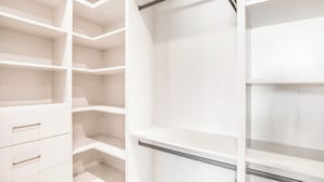 A white closet with open shelves and a metal rod. - Villa Camellia - Charming 5 BR Home in the heart of Studio City (Studio City)