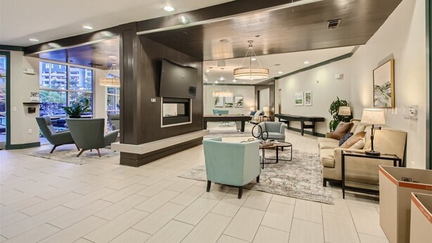 A spacious living area with a fireplace, comfortable seating, and a pool table. - Stylish 2-bedroom in the Gulch - Walk to Nashville's hot spots! (Nashville)