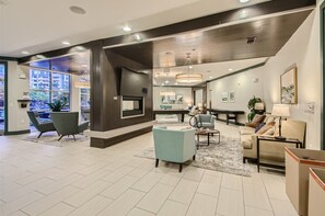 A spacious living area with a fireplace, comfortable seating, and a pool table. - Stylish 2-bedroom in the Gulch - Walk to Nashville's hot spots! (Nashville)