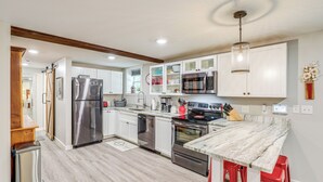 A modern kitchen with stainless steel appliances, white cabinets, and a marble countertop. - Walk to Downtown Weaverville: Quiet Apartment (Weaverville)