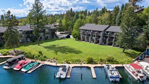 A resort with multiple buildings, a marina, and a well-maintained lawn. - Waterfront Condo 5-Minute Walk to DT Bigfork (Bigfork)