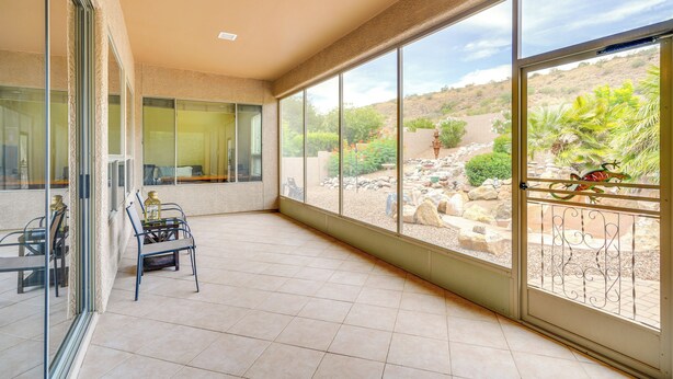 A spacious balcony with a glass door leading to a patio area. - Spacious Home in Saddlebrooke 55-plus Community! (Saddlebrooke)