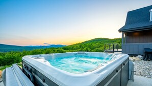 A hot tub with a clear view of a mountainous landscape in the background. - The Best Mountain Views! You can't stop looking at them! (Hanover)