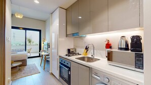 A modern kitchen with a built-in oven, a dishwasher, and a coffee maker.
