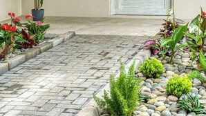 A clean, minimalist entrance with a stone-paved pathway leading to a door.
