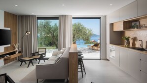 A modern kitchen with a large island, dining area with a sofa and chairs, and a view of the sea. - Lavish Villa O with Panoramic Elefiti Islands View, Six Bedrooms with a Pool (Dubrovnik)