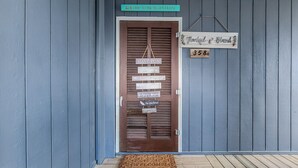 A wooden door with multiple signs, including "Welcome to the Beach House" and "Have Fun." - Topsail Reef 358: Dream2B - Oceanfront Getaway! (North Topsail Beach)