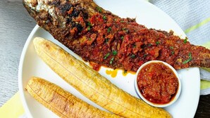 A plate with grilled fish, French fries, and a side of tomato sauce. - Sleeps 2 With Free Parking and Wi-fi (Birmingham)