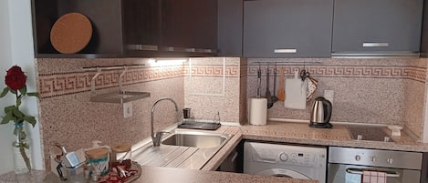 Een koelkast, een oven, een kookplaat, een koffiezetapparaat/waterkoker