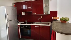 A compact kitchen with a stainless steel refrigerator, a Bosch dishwasher, and a sink with a modern faucet. - Delightful Loft in Pigneto - to Colosseum in 10 minutes (Roma)