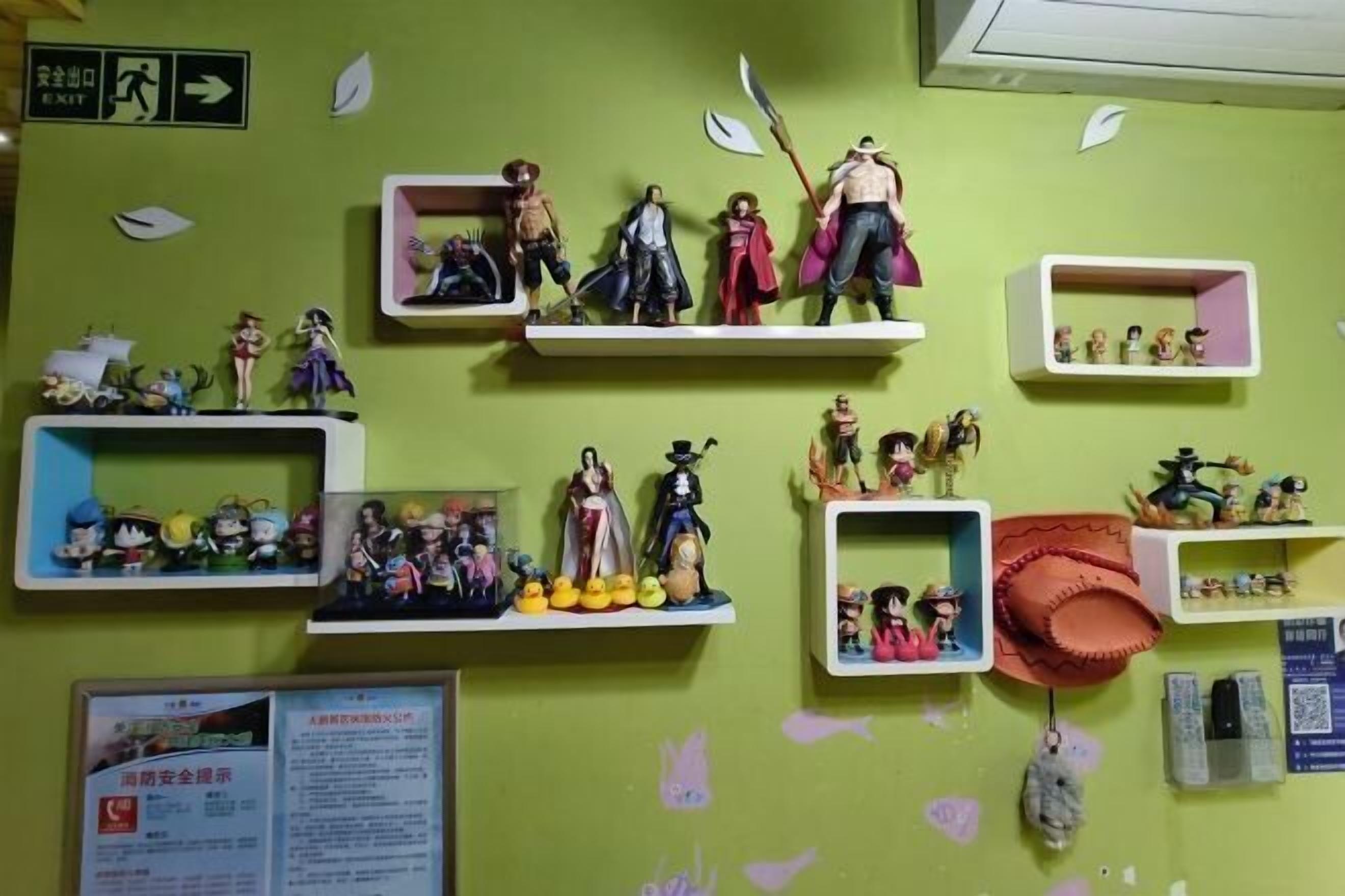 A wall with multiple shelves displaying various figurines and collectibles.