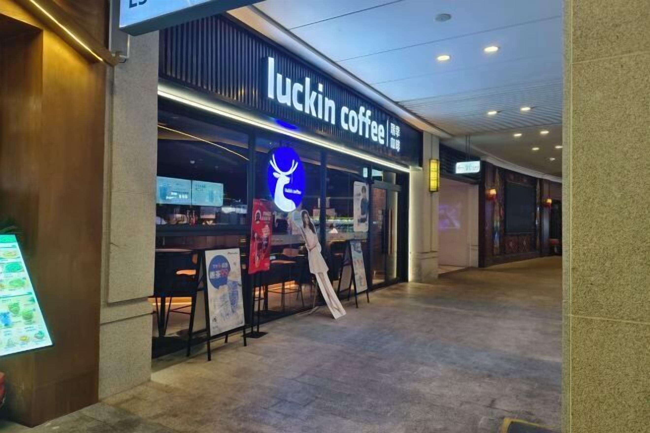 A coffee shop named 'luckin coffee' with a modern storefront and a visible menu board outside.