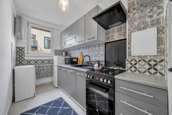 Enjoy cooking in this well-equipped kitchen with an oven, stovetop, and range hood.