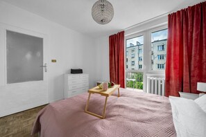 Relax in this serene bedroom with a large bed, bedside table, and dresser, offering a peaceful view of the surrounding landscape.