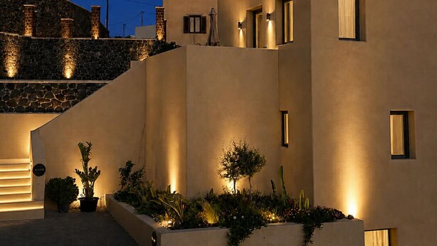 A modern building with a unique architectural design, featuring curved walls and multiple windows.