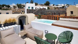 A rooftop terrace with a swimming pool, outdoor seating, and a view of the surrounding buildings.