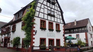 Ein traditionelles Fachwerkhäuschen mit einem Schild, auf dem "Zur Alten Gerberei" steht.