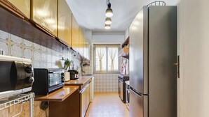 A kitchen with a stainless steel refrigerator, a built-in oven, a microwave, and a toaster. - The Popes' Oasis - 2 steps from Trastevere and Historical Center (Roma)