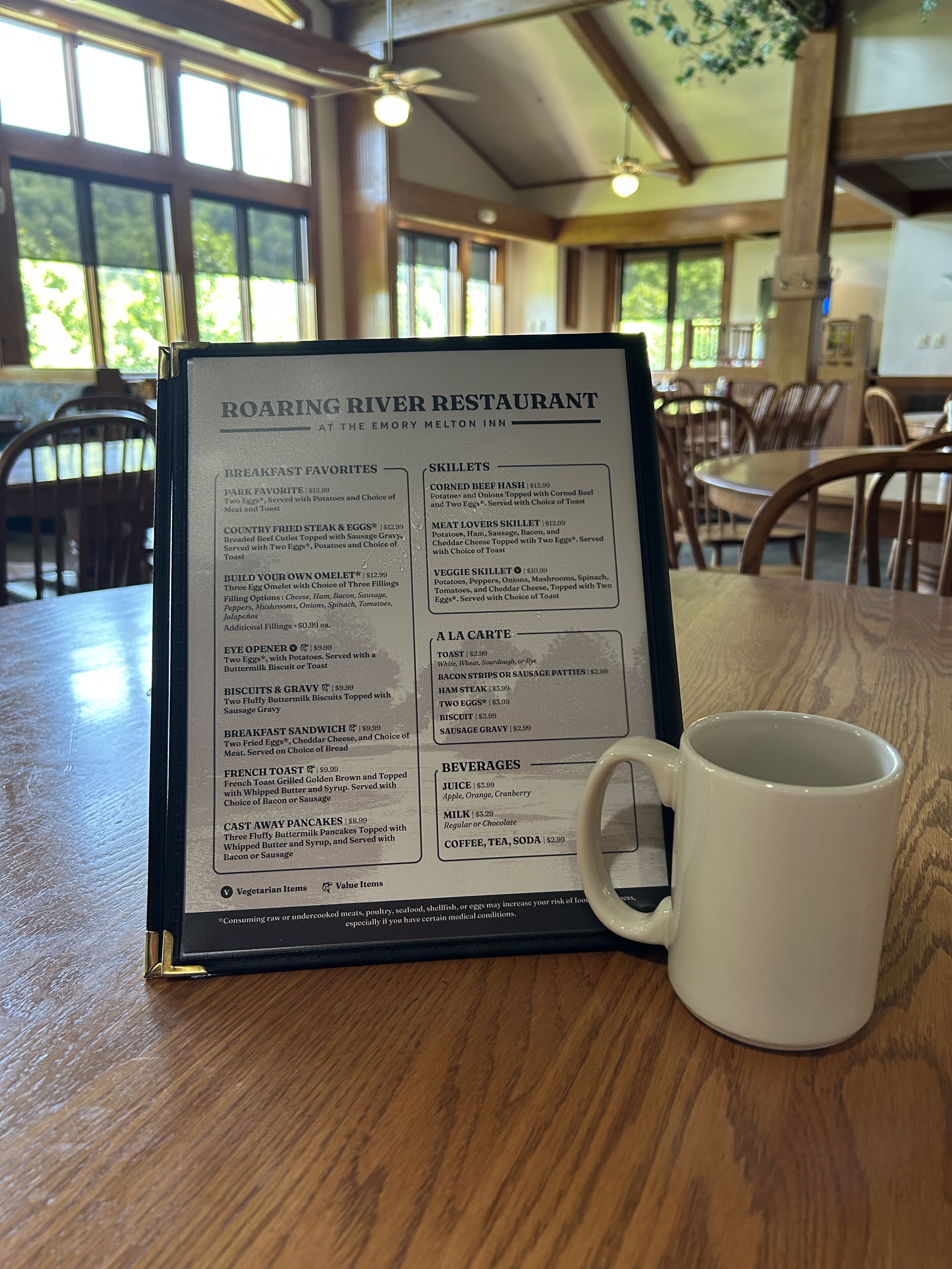 A menu at Roaring River Restaurant with breakfast and lunch options, including items like corned beef hash and veggie skillet.